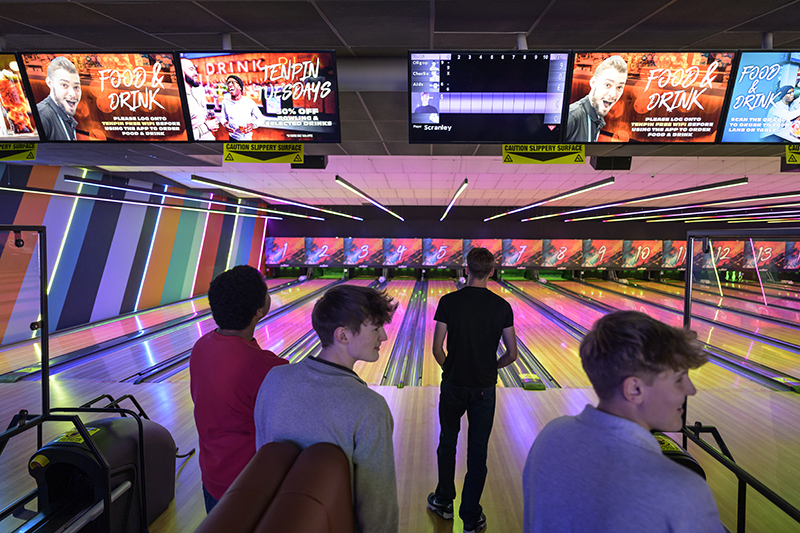Bowling lanes with overhead screens